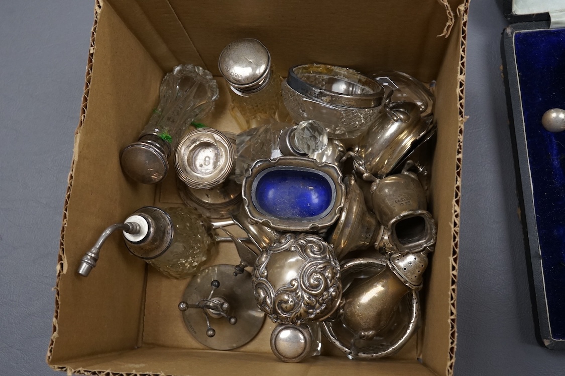 A George V cased eight piece silver condiment set, by Walker and Hall, Sheffield, 1912/1913, together with a group of assorted silver condiments and silver mounted toilet jars, etc.